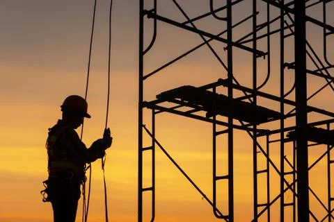 Silhouette engineer working in the construction site Stock Photos