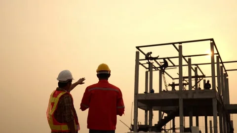 Silhouette of engineers working at the construction site at sunset. Stock Footage 151626090