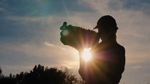 Silhouette of a farmer with a box of fruit on his shoulder Stock Footage 115989069