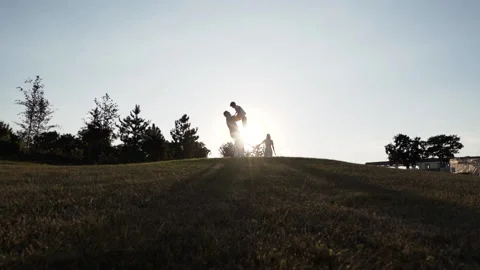 Silhouette of father and son playing, enjoying sunset in wheat field in nature Stock Footage 143991753