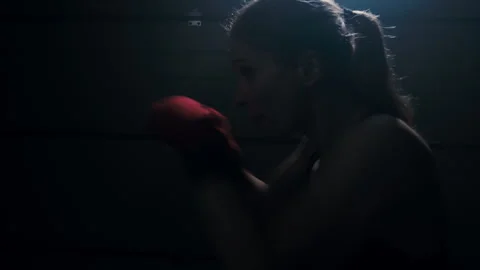 Silhouette of a fighter boxer practicing quick strikes with shadow boxing  Stock Footage 274448786