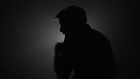 Silhouette of fighter punching in dark Stock Footage 104049989