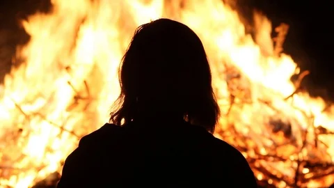 Silhouette by the fire Stock Footage 122355050