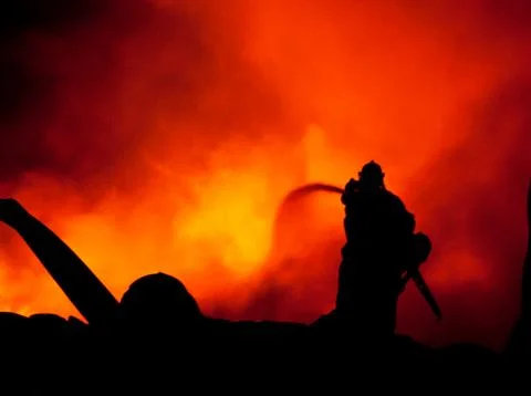 Silhouette of firemen Stock Photos