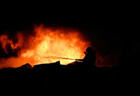 Silhouette of firemen Stock Photos