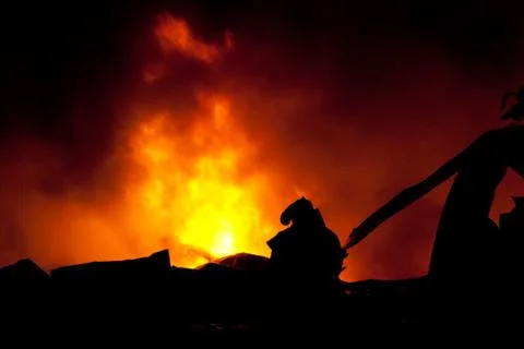 Silhouette of firemen Stock Photos