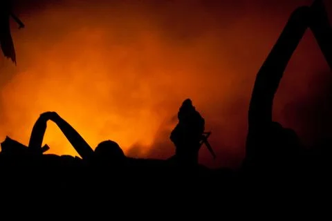 Silhouette of firemen Stock Photos