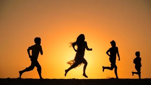 Silhouette of five kids running at hill with sunset Stock Footage