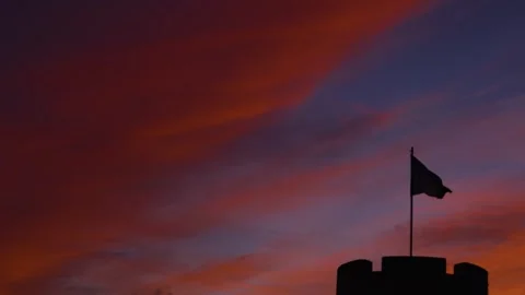 Silhouette Flag Flapping in the wind, colorful sunset, castle Video stock 305117477