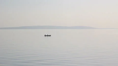 Silhouette of a floating boat at sunset Stock Footage 55335783