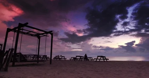 Silhouette footage of relaxing wooden chairs and lonely women Stock Footage