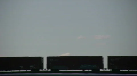 Silhouette of a freight train moving down tracks (High Definition) Video stock 360840