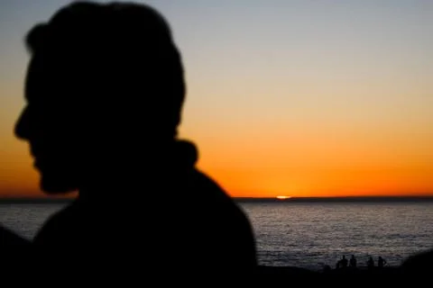 Silhouette in front of a sunset Stock Photos