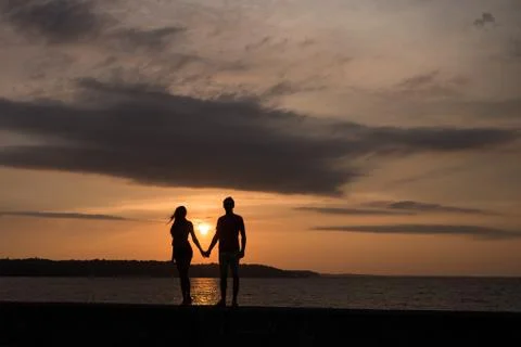 Silhouette in front of a sunset Stock Photos
