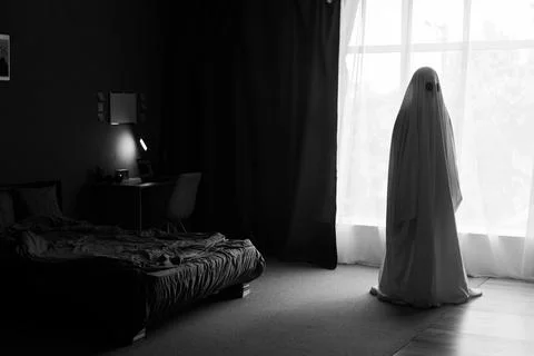 Silhouette of ghost in window inside bedroom at night. Horror scene. Hallow.. Stockfoto's