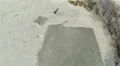 Silhouette of going person on frozen lake. Aerial HD Footage
