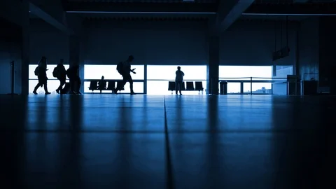 Silhouette of group of students walking through airport terminal with bags Stock Footage 126207001