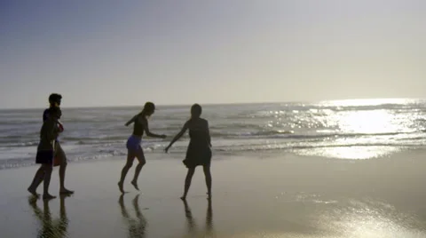 Silhouette of group walking on beach Stock Footage 52603437