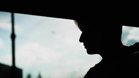 The silhouette of a guy's face with a thoughtful face against the sky Stock Footage 230191269