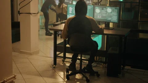 Silhouette of hacker coding encryption to plant trojan virus Stock Footage 232376231