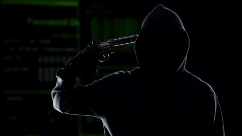 Silhouette of hacker shooting himself with gun on computer code background Stock Footage 83563159