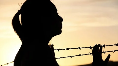Silhouette, hand on barb wire Stock Footage 99274265