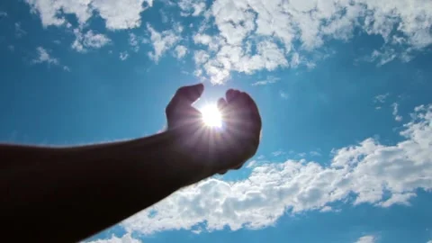 Silhouette Hand Opening to Catch Sun in Sky Stock Footage 346026441