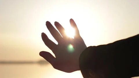 Silhouette Hand Reaching Towards Bright Sun Stock Footage 346029836