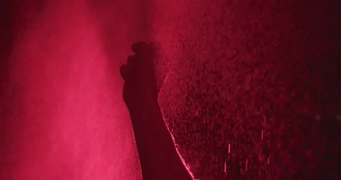 Silhouette of hand in red light in super slow motion reaches upward Vidéo 325964456