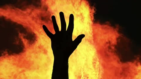 Silhouette hand stop fire flame | Stock Video | Pond5
