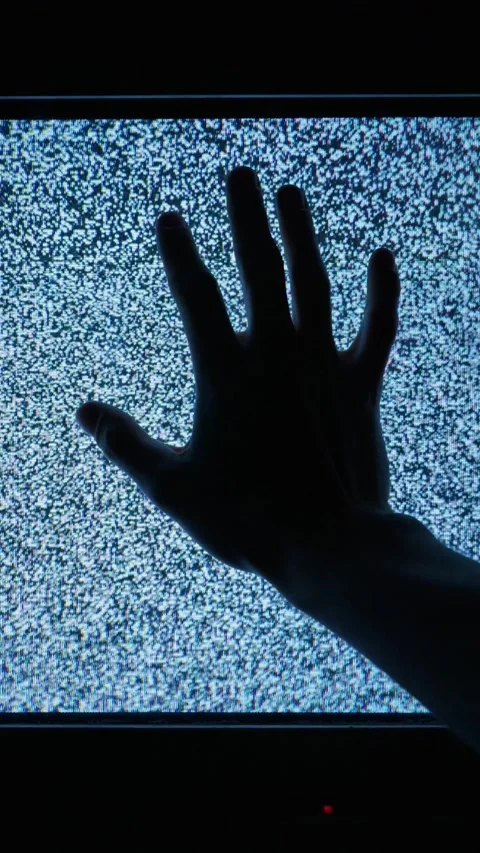 Silhouette of Hand Touching Television Screen with Static Noise in Dark Room Stock Footage 335635662