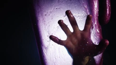 Silhouette of hand trapped behind purple slime film in dark cinematic scene. Stock Footage 334593228
