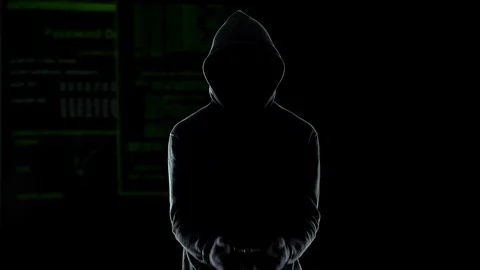 Silhouette of handcuffed angry hacker on animated computer code background Video stock 83563500