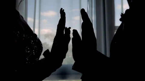 The silhouette of the hands of the couple by the window Stock Footage 75073374