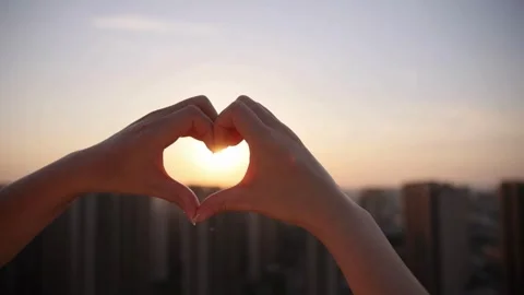 Silhouette of Hands Forming Heart Shape at Sunset Video stock 309544218