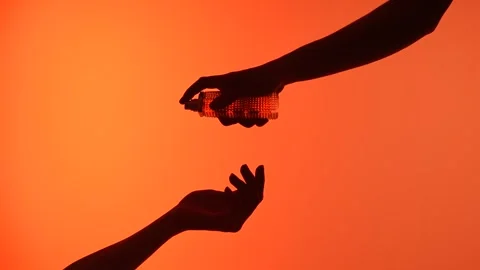 Silhouette of hands interacting with perfume on a bright orange background Stock Footage 313525643
