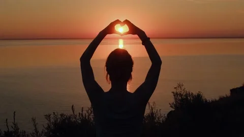 Silhouette of hands making heart shape at sunset. Stock Footage 197325218