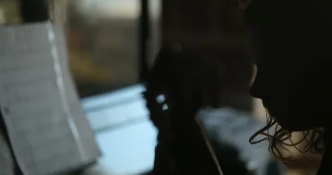 Silhouette hands playing classical guitar near piano in sunset backlight Stock Footage 331318006