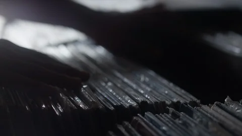 Silhouette of hands sifting through a row of vinyl records Video stock 122597894