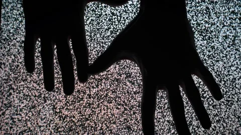Silhouette Hands Touching TV Screen with Static Noise Interference Stock-Footage 307299732