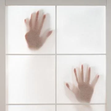 Silhouette of hands trapped behind translucent screen Stock Photos