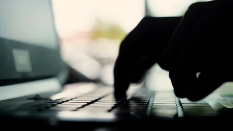 Silhouette of hands typing on computer keyboard Stock-Footage 113897949