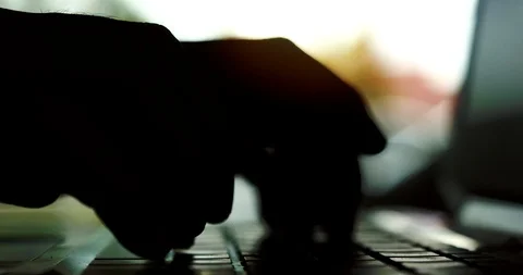 Silhouette of hands typing on computer keyboard Stock Footage 113901859