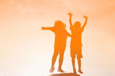 Silhouette of a happy children and happy time sunset Stock Photos