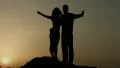 Silhouette of happy couple enjoying sunset together, looking in future with hope HD Footage
