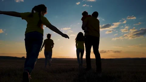 Silhouette of happy family. Family run in field in park. Silhouette of run Stock Footage