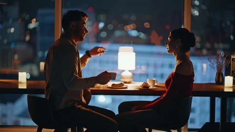 Silhouette happy pair talking at romantic dinner in night cafeteria. Man talking Stock Footage 340110392