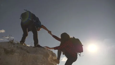 Silhouette of a helping hand between two climbers. Happy family hiking. climbing Stock Footage 142315611
