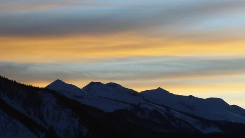 Silhouette of high altitude mountains with cloudy sky panorama during sunset Stock Footage 121576176