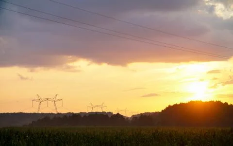 Silhouette high voltage pole on sky sunset background. Stock Photos